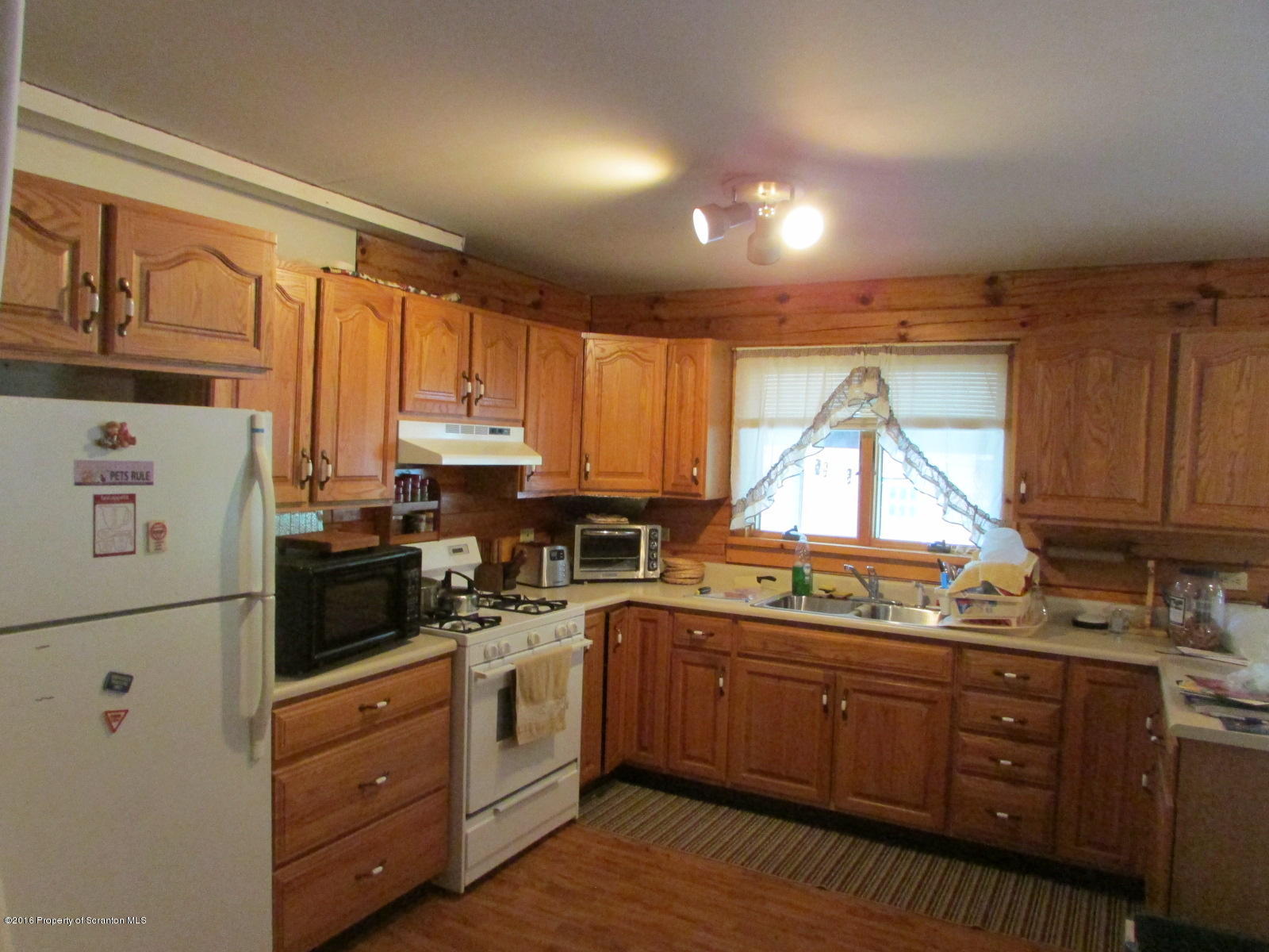 619 Litwin Road Meshoppen, PA 18630 - Photo 2 of 12 a kitchen with kitchen island granite countertop white cabinets white appliances a sink and a window