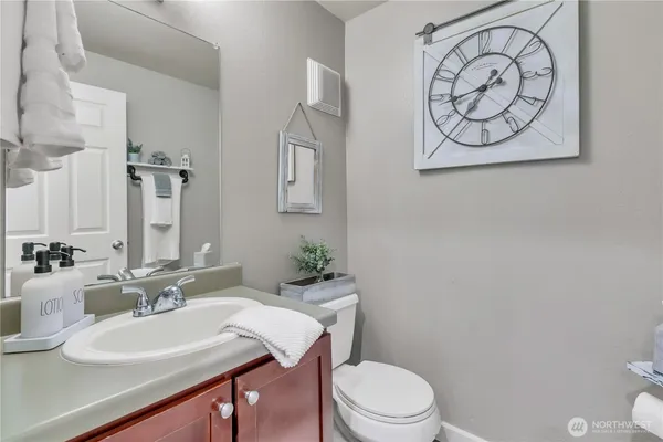 a bathroom with a sink a toilet and mirror