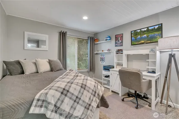a bedroom with a bed and a chair