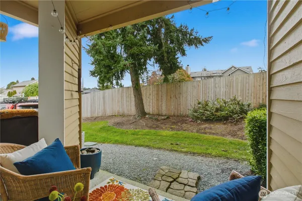 a view of backyard with outdoor seating and plants