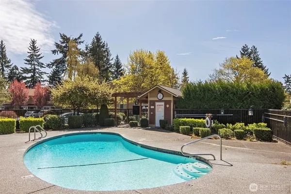 swimming pool view with a seating space and a garden view