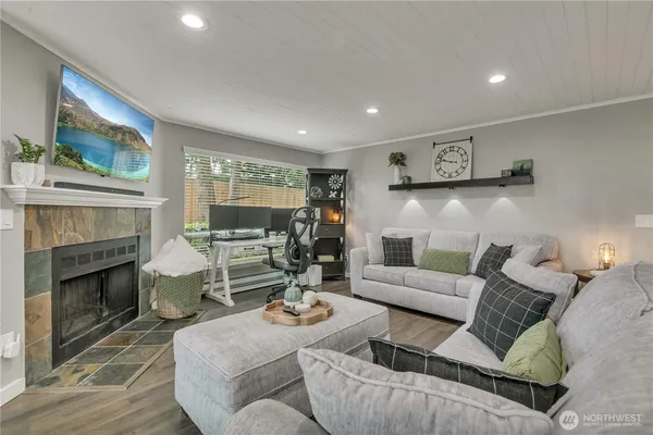 a living room with furniture and a fireplace