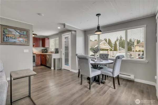 a view of a dining room with furniture window and wooden floor
