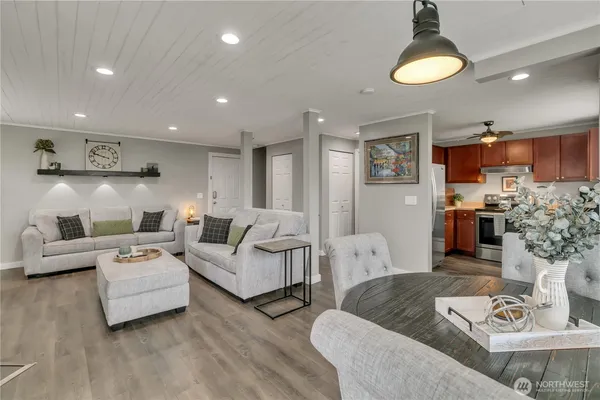 a living room with furniture and a kitchen view