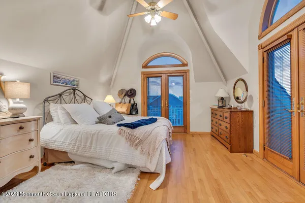 a bedroom with a bed and a chandelier