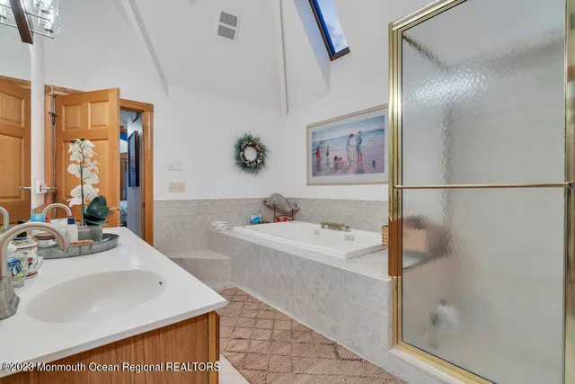 a bathroom with a sink a bathtub and a shower