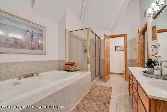 a spacious bathroom with sink shower and bathtub