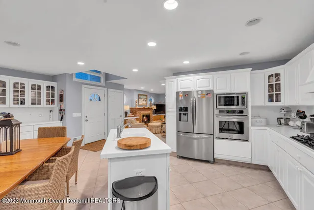 a kitchen with refrigerator and cabinets