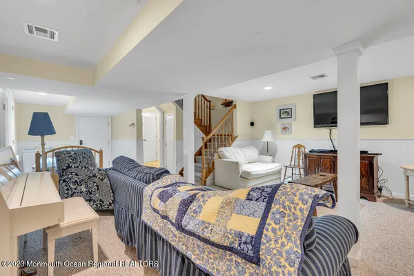 a living room with furniture a flat screen tv and a fireplace