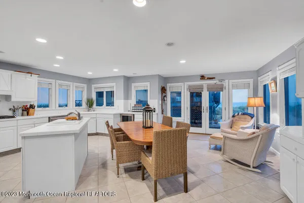 a living room with stainless steel appliances kitchen island granite countertop furniture and a kitchen view