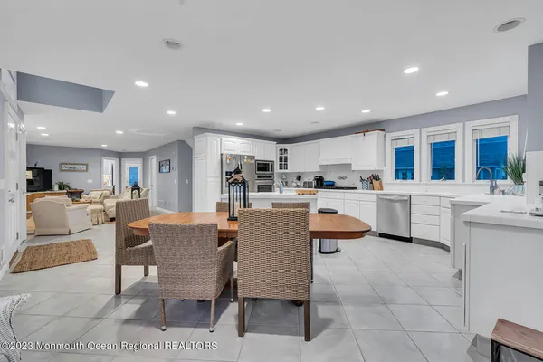 a kitchen with a dining table chairs and view of kitchen