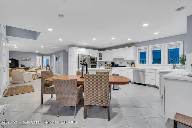a kitchen with a dining table chairs and view of kitchen