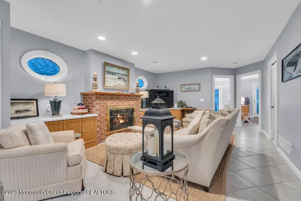 a living room with furniture a fireplace and a large window