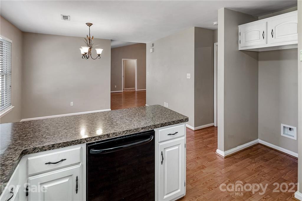 8577 Unity Church Road Denver, NC 28037 - Photo 12 of 33 a view of a kitchen counter space and wooden floor