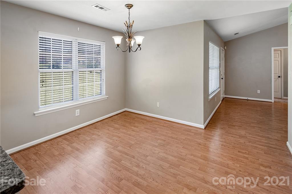8577 Unity Church Road Denver, NC 28037 - Photo 15 of 33 a view of empty room with wooden floor and fan