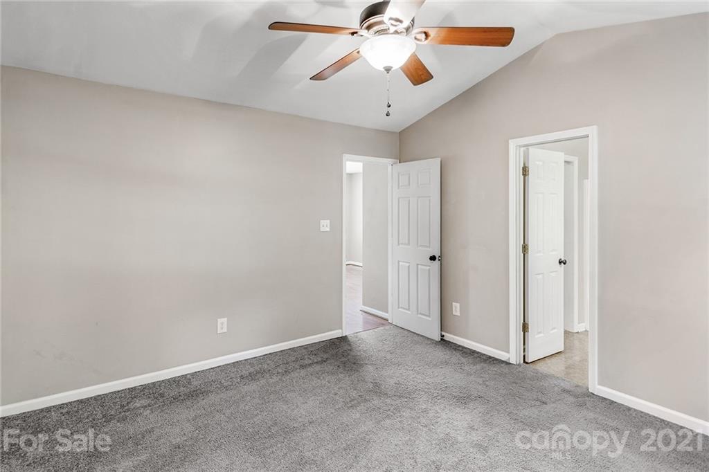 8577 Unity Church Road Denver, NC 28037 - Photo 17 of 33 an empty room with closet and a chandelier fan