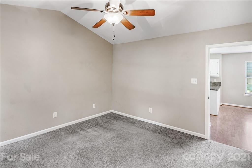8577 Unity Church Road Denver, NC 28037 - Photo 18 of 33 an empty room with chandelier fan and table