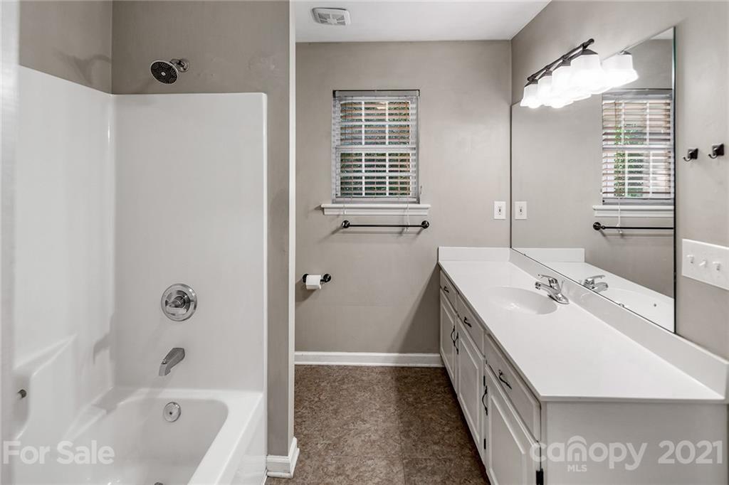 8577 Unity Church Road Denver, NC 28037 - Photo 21 of 33 a bathroom with a tub sink and mirror