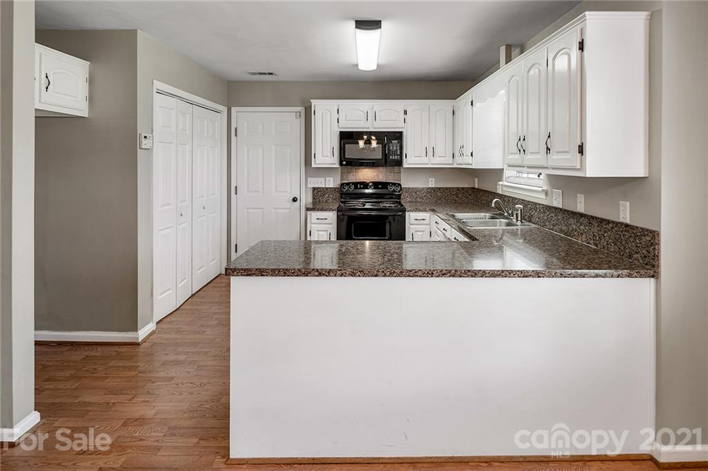 8577 Unity Church Road Denver, NC 28037 - Photo 9 of 33 a large kitchen with granite countertop a refrigerator and a sink