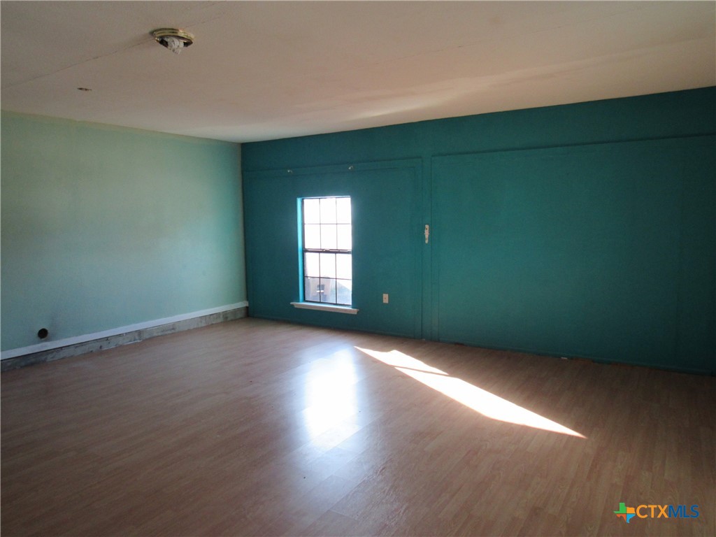 1325 Paseo Del Cobre Temple, TX 76502 - Photo 11 of 15 a view of an empty room with wooden floor and a window