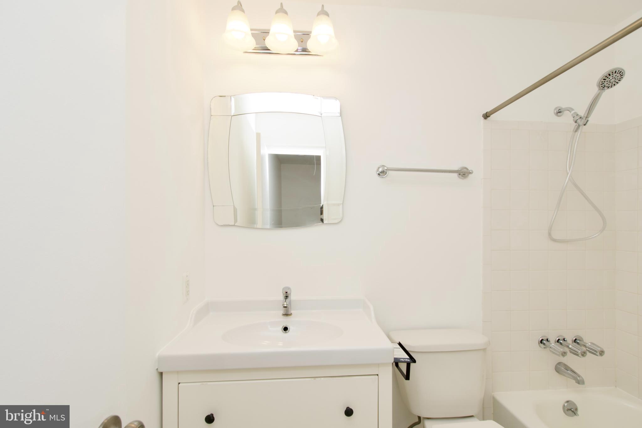 1448 Orleans Court Crofton, MD 21114 - Photo 21 of 32 a bathroom with a sink a toilet and shower