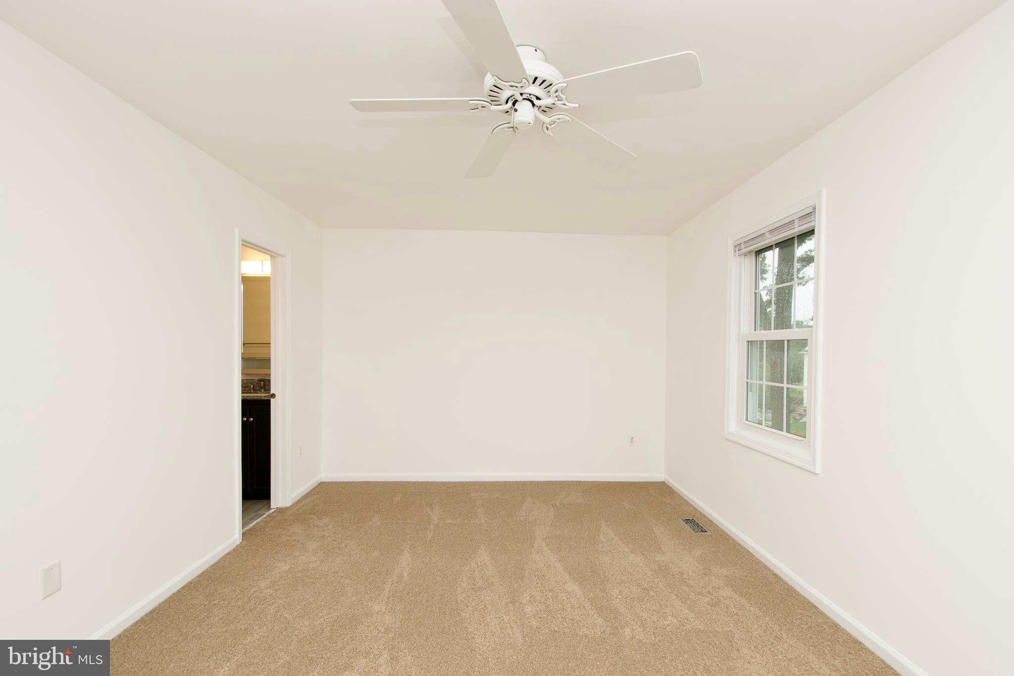 1448 Orleans Court Crofton, MD 21114 - Photo 24 of 32 an empty room with windows and fan
