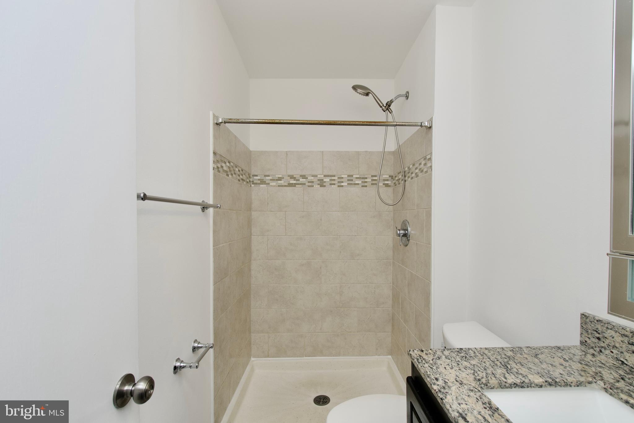 1448 Orleans Court Crofton, MD 21114 - Photo 28 of 32 a bathroom with a granite countertop shower and a sink