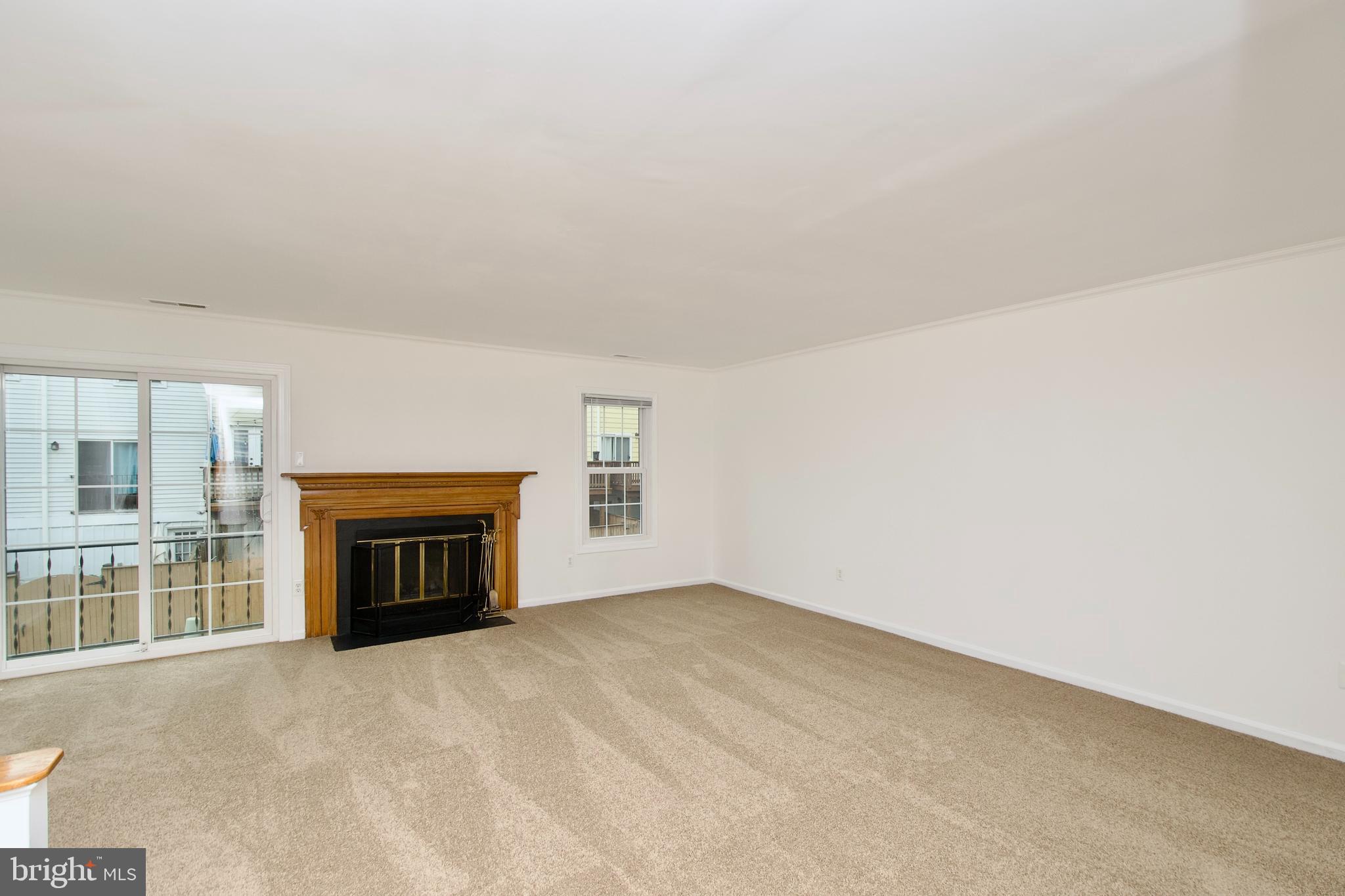 1448 Orleans Court Crofton, MD 21114 - Photo 5 of 32 an empty room with fireplace and a window
