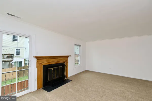 a view of empty room with a fireplace