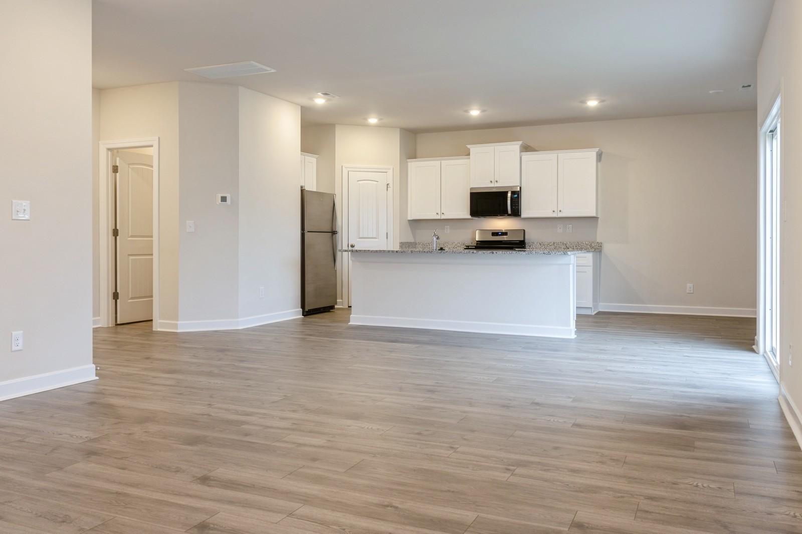 2322 Nabali Way Murfreesboro, TN 37127 - Photo 10 of 22 a view of a kitchen with kitchen island a sink wooden floor and a refrigerator