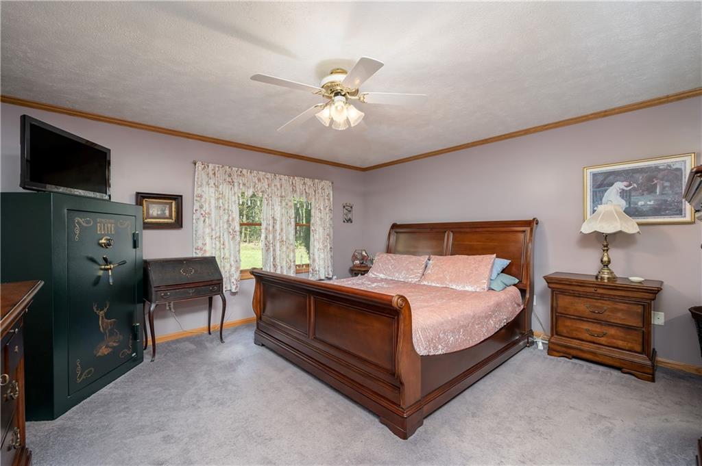 360 Sopher Road Grove City, PA 16127 - Photo 13 of 25 a bedroom with a bed and a chandelier