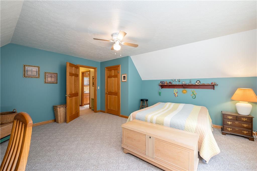 360 Sopher Road Grove City, PA 16127 - Photo 18 of 25 a bedroom with a bed and a chandelier