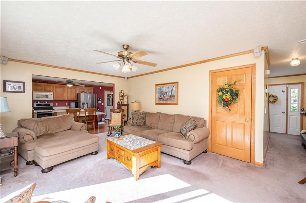 360 Sopher Road Grove City, PA 16127 - Photo 9 of 25 a living room with furniture and a chandelier