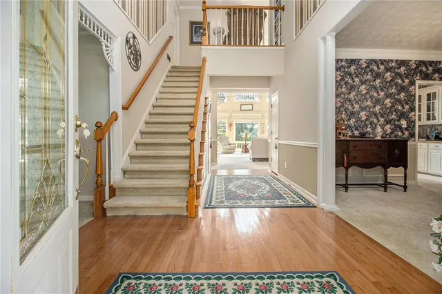 a view of entryway and hall with wooden floor