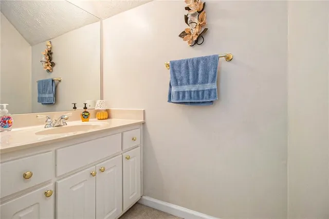 a bathroom with a sink vanity and a mirror