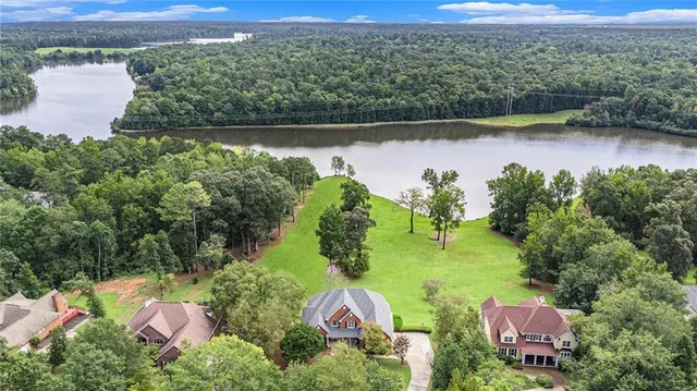 an aerial view of a houses with a lake view