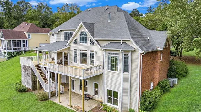 a balcony with wooden floor table and chairs