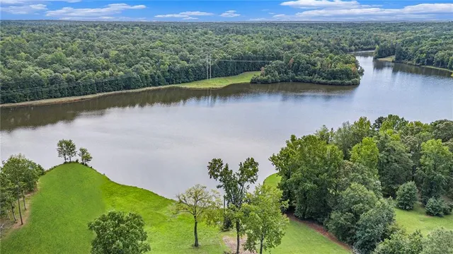 an aerial view of a houses with a lake view