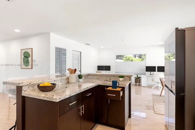 a kitchen with lots of counter top space and living room