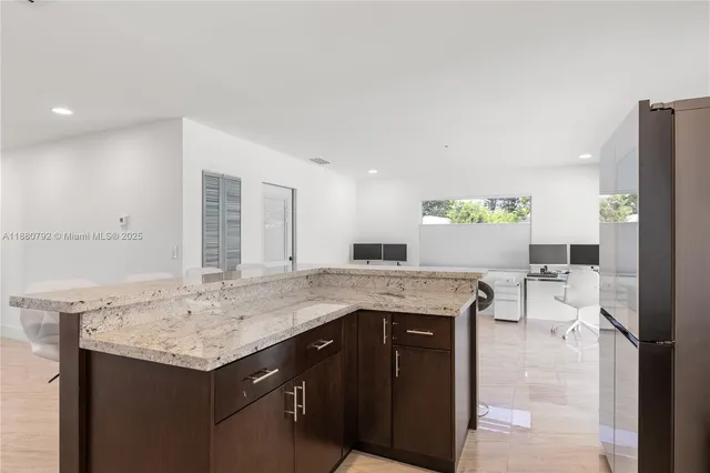 a kitchen with a stove a refrigerator and countertop