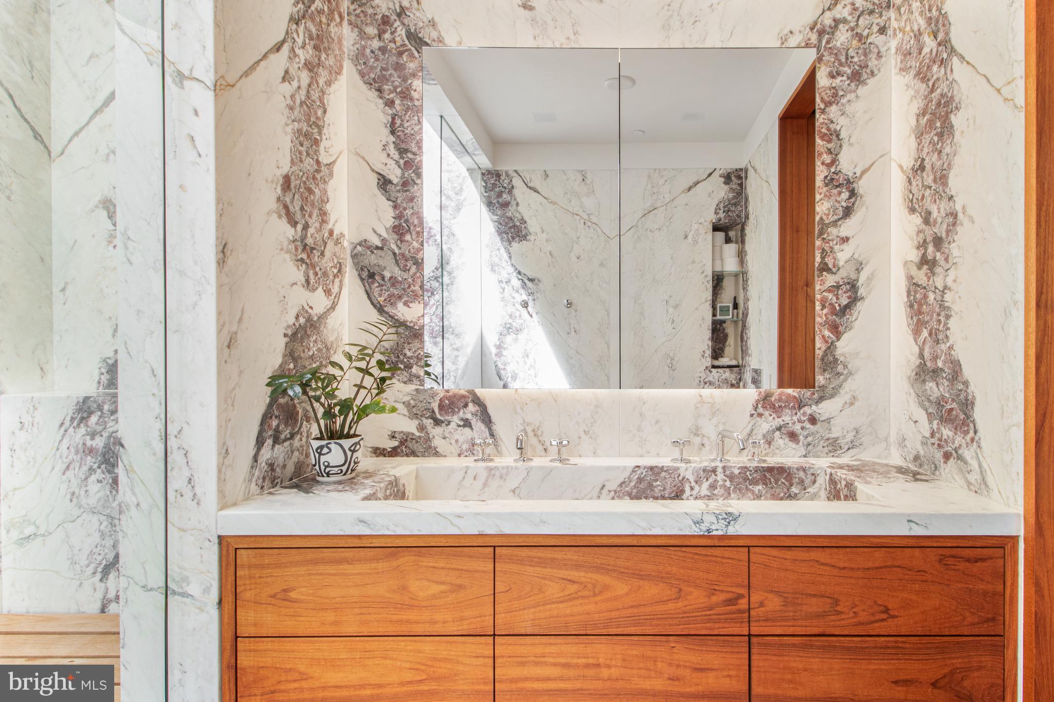1711 14th Street Northwest, Unit PH Washington, DC 20009 - Photo 23 of 39 a bathroom with a granite countertop sink and a mirror