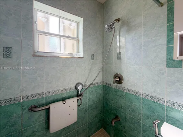 a spacious bedroom with a bed and a shower