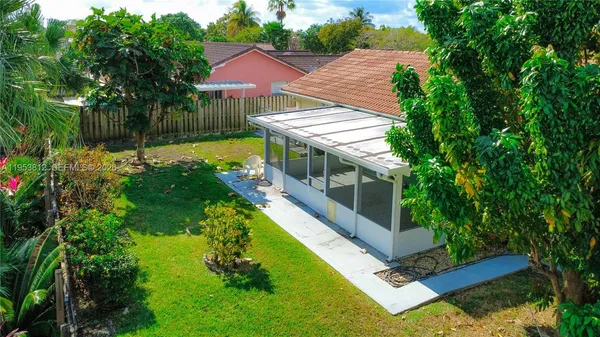 a view of a house with backyard and sitting area