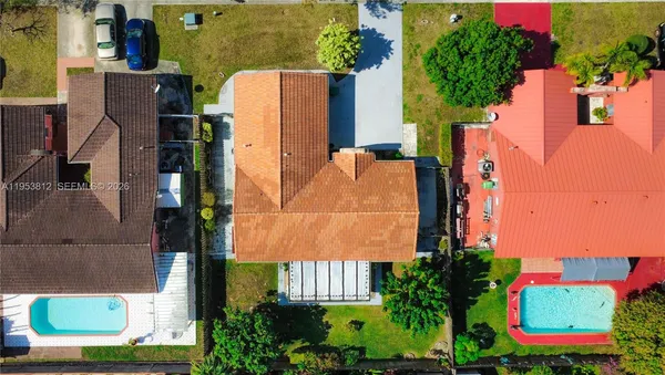 an aerial view of a multi story residential apartment building with yard