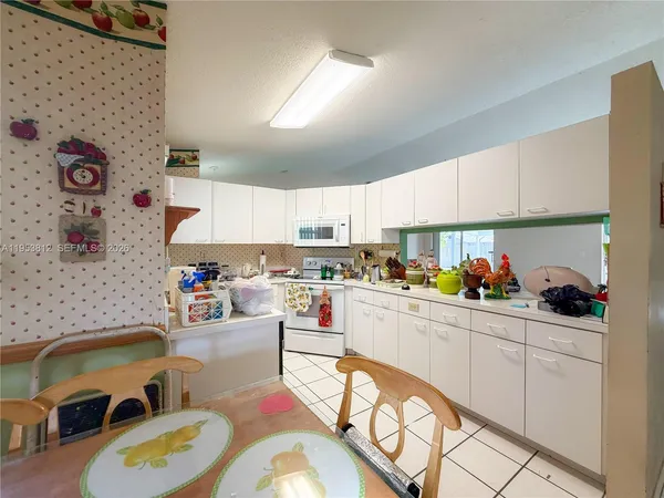 a kitchen with a sink a stove and cabinets