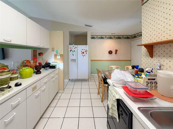 a kitchen with a sink a cabinets and window