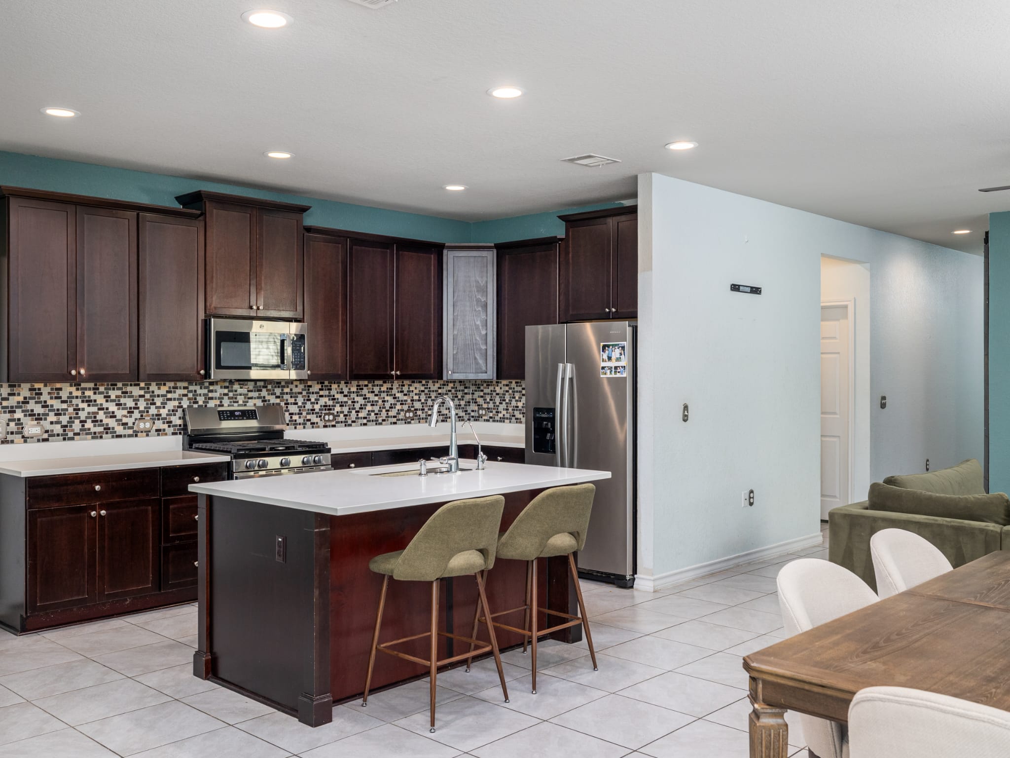 1919 Rinker Ranch Drive Austin, TX 78725 - Photo 2 of 30 Kitchen with a breakfast bar, stainless steel appliances, an island with sink, recessed lighting.