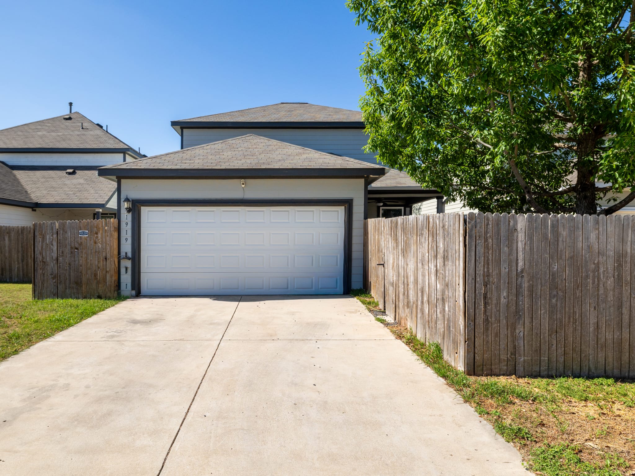 1919 Rinker Ranch Drive Austin, TX 78725 - Photo 23 of 30 View of front of house with concrete driveway, an attached garage, and roof with shingles