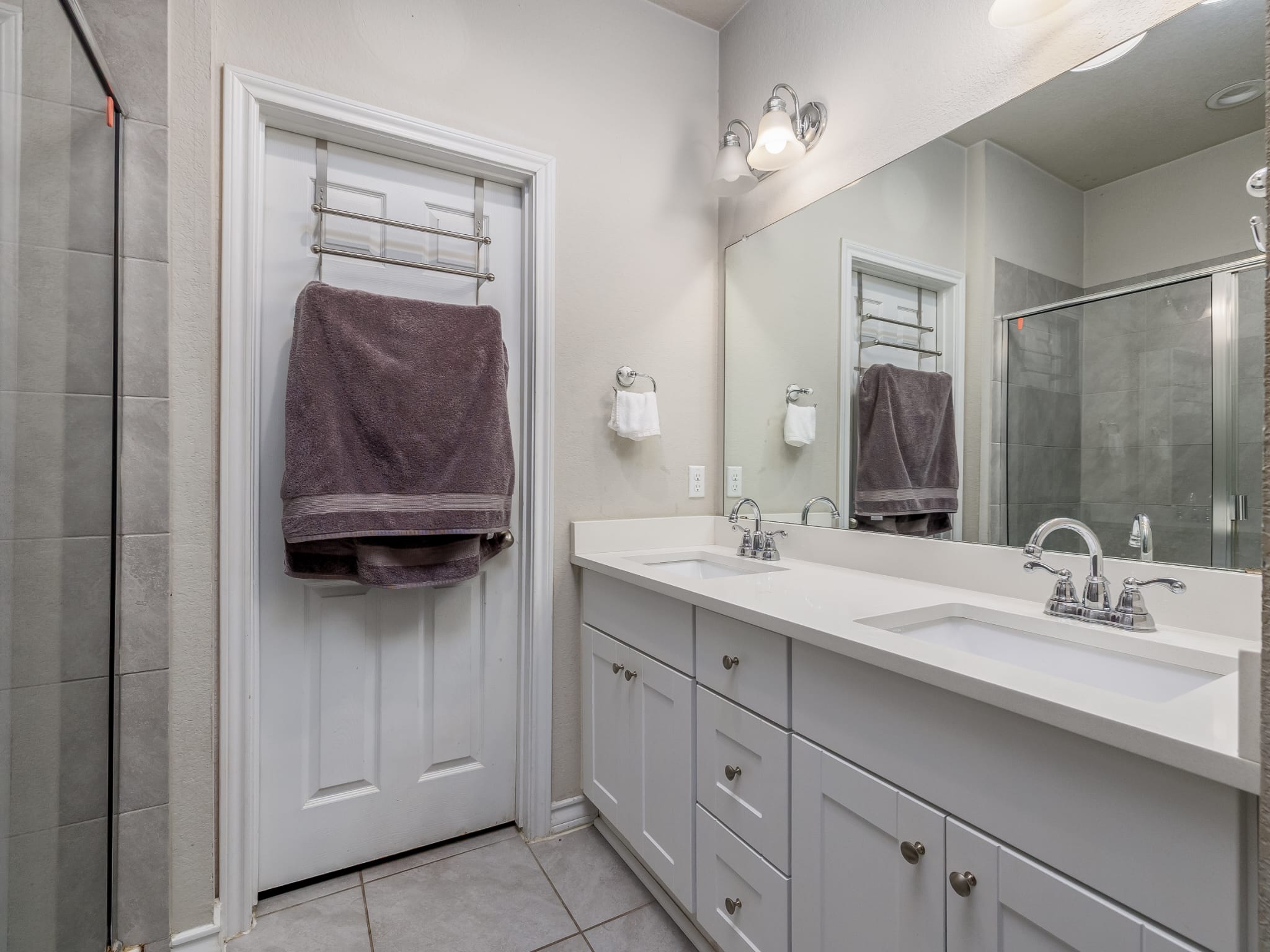 1919 Rinker Ranch Drive Austin, TX 78725 - Photo 10 of 30 Bathroom with a shower stall, double vanity, and light tile patterned flooring
