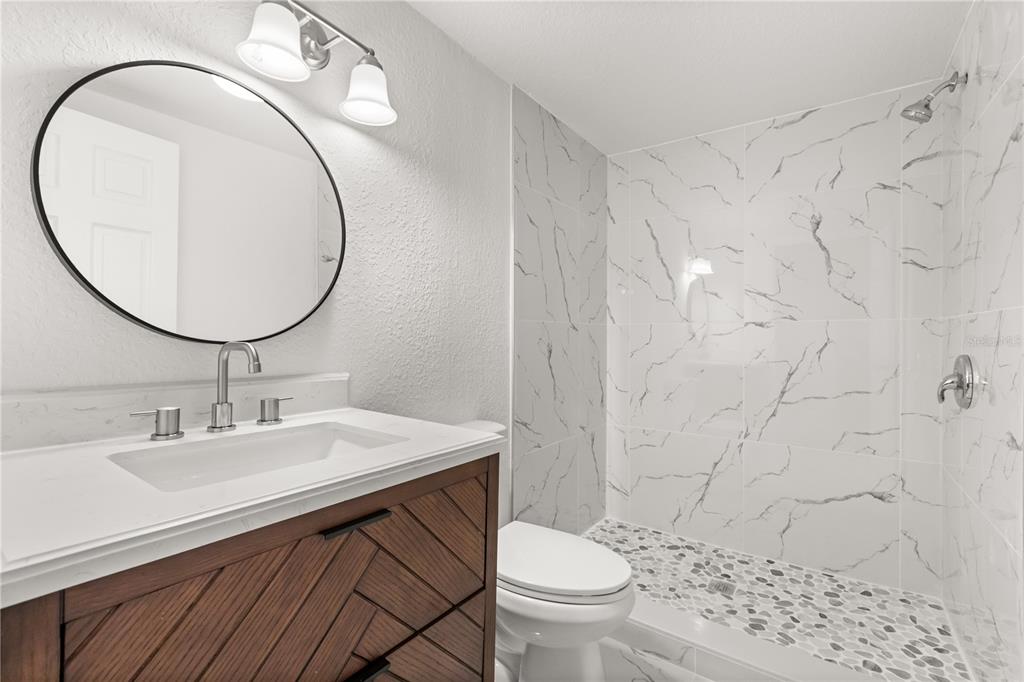 1251 Northwest 23rd Avenue Ocala, FL 34475 - Photo 15 of 34 a bathroom with a sink a toilet and a mirror